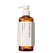 HONEYQUE 蜂蜜蛋白洗发水单瓶正面展示，琥珀色透明瓶身搭配白色泵头与极简标签设计。