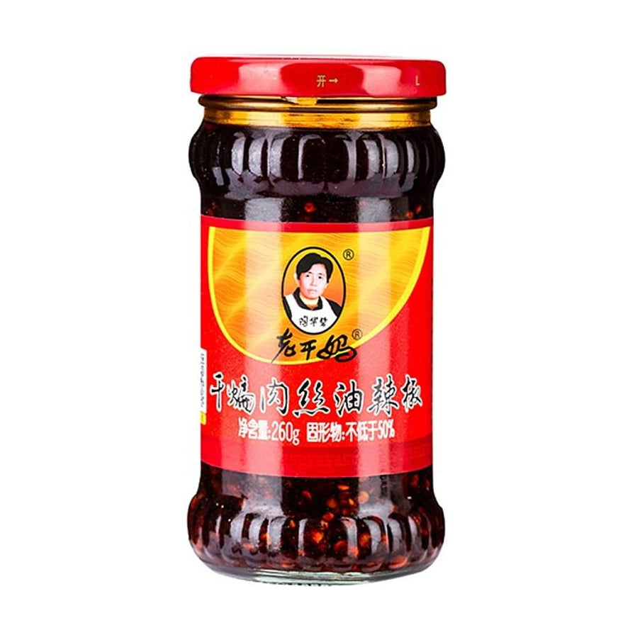 老干妈干煸肉丝油辣椒260g玻璃瓶装正面图，展示经典陶华碧头像标志及红色产品标签。