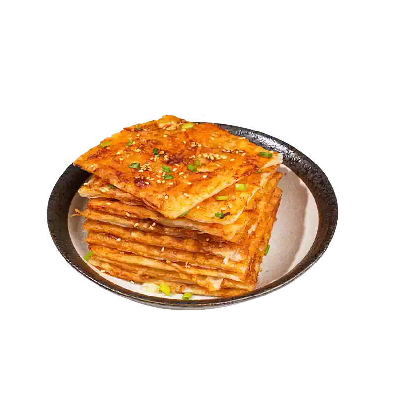煎制后的土家酱香饼特写，表面金黄酥脆并刷有红色酱料