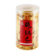 无名小卒脆锅巴210g透明罐装，红色标签上印有脆锅巴字样，展示原味锅巴的焦黄成色。