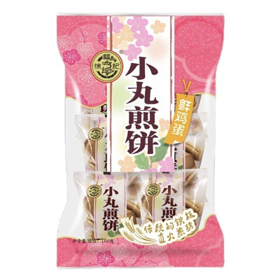 徐福记小丸煎饼鲜鸡蛋味独立包装正面图，展示金黄酥脆的传统铁板直火零食。